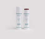 Two bāeo bare tint 'palisades' tubes, labeled "Mineral Lip + Cheek Tint" with a palm tree on the white label, stand side by side—one capped, one open to reveal a deep red hydrating tint for buildable color and a natural dewy finish.