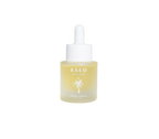 A small bottle of bare glow by Bare Essential Organics features a white dropper cap. The translucent bottle with yellow oil displays a palm tree logo and text on the front. Infused with antioxidants for radiant skin, it stands out against the plain black background.