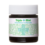 A small jar of Triple Mint Enamelizer Toothpaste from Living Libations highlights its organic ingredients, which include nano-hydroxyapatite, coconut oil, spearmint, and essential oils of tea tree and thyme.