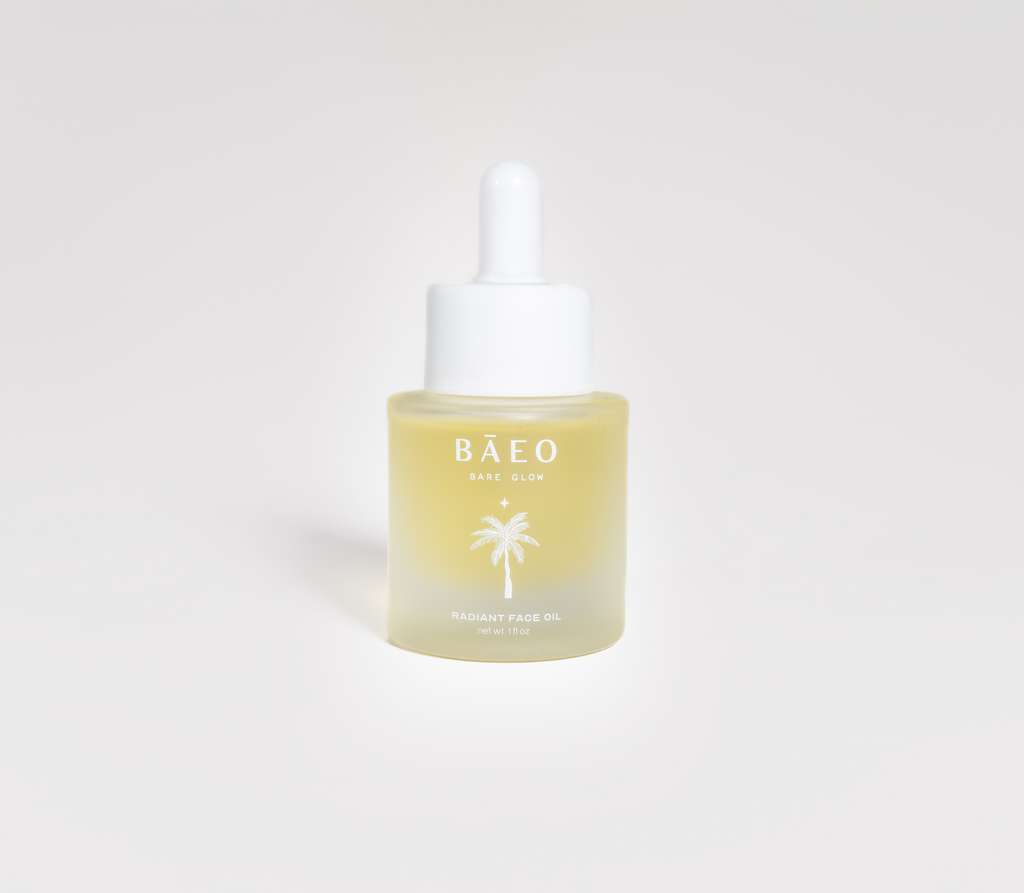 A small frosted glass dropper bottle labeled "bāeo bare glow" with a palm tree graphic, containing organic squalane face oil for radiant skin, sits against a plain white background.