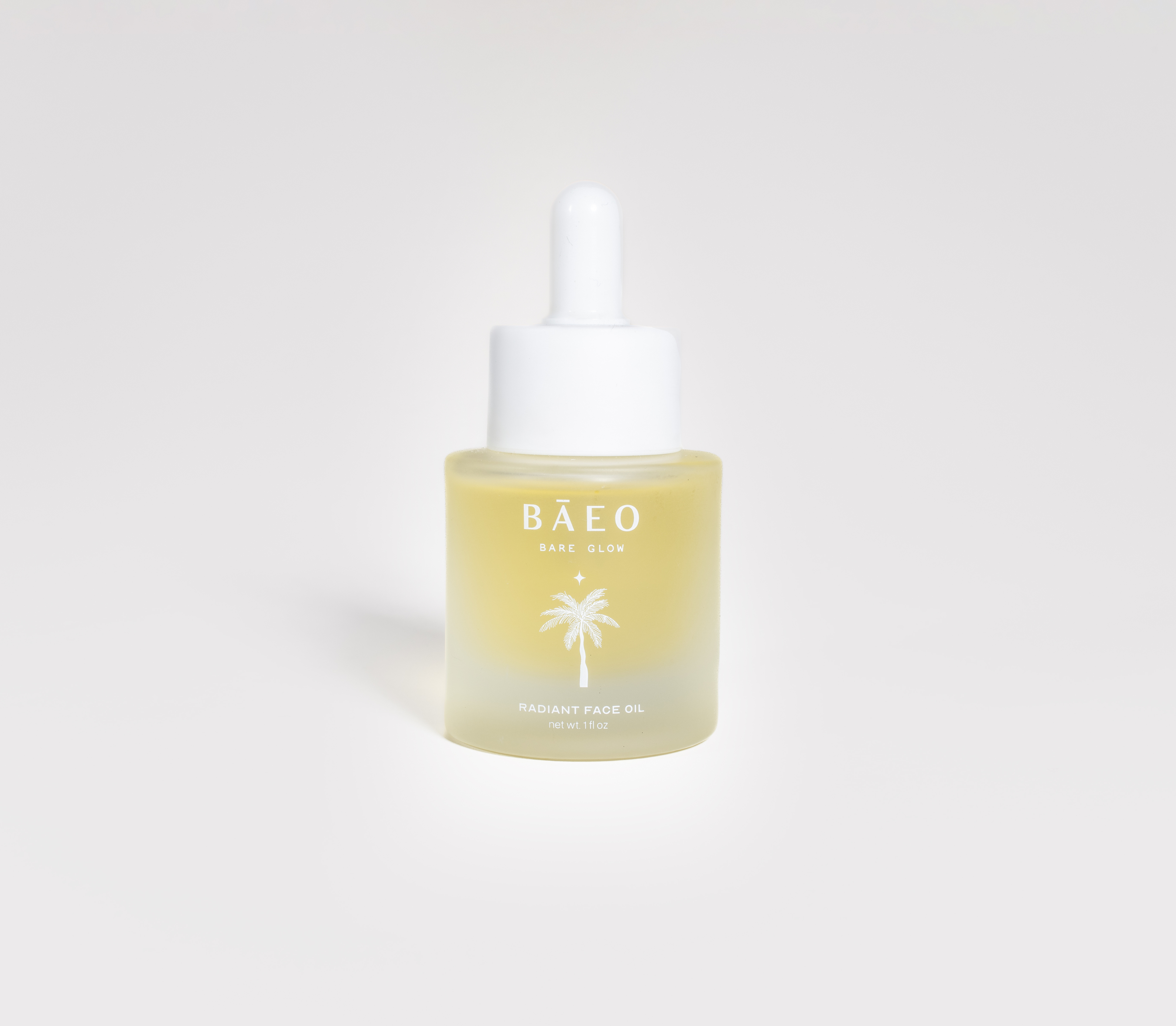 A small frosted glass dropper bottle labeled "bāeo bare glow" with a palm tree graphic, containing organic squalane face oil for radiant skin, sits against a plain white background.
