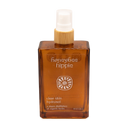 The Honeybee Hippie clear skin hydrosol comes in an amber spray bottle with a wooden cap and white nozzle, made from organic botanicals to complement green tea skincare routines.