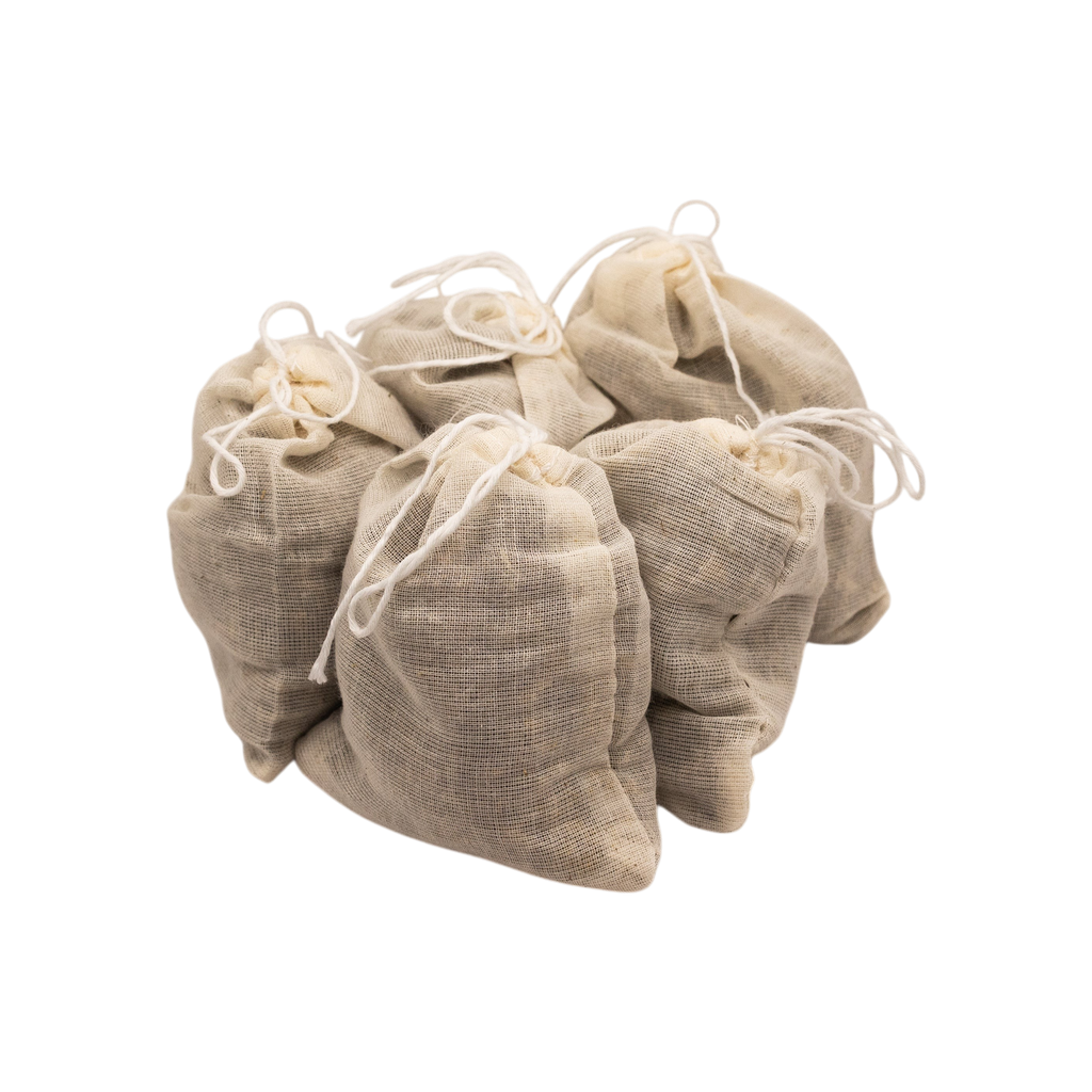 Four small beige muslin drawstring bags of Honeybee Hippie postpartum herbal sitz bath are grouped against a white background. Perfect for postpartum recovery, each bag contains a soothing herbal blend.