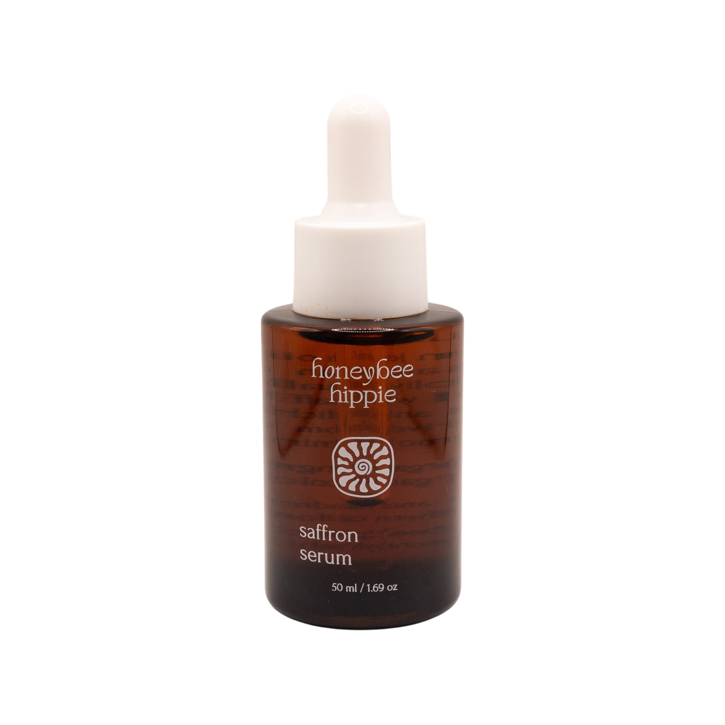 A brown glass bottle with a white dropper cap labeled "Honeybee Hippie saffron serum" sits on a plain white background.