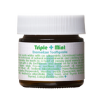 A small jar of Triple Mint Enamelizer Toothpaste from Living Libations highlights its organic ingredients, which include nano-hydroxyapatite, coconut oil, spearmint, and essential oils of tea tree and thyme.