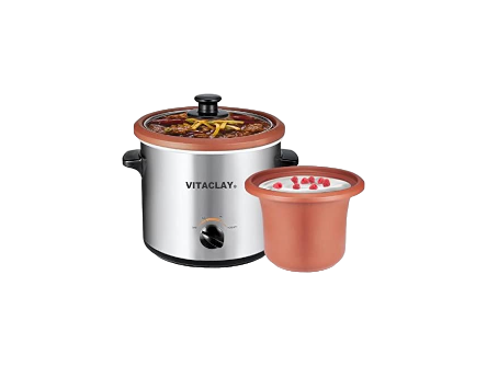 The VitaClay® Chef 3-in-1 Clay Slow Cooker, Yogurt & Baby Food Maker includes a clay pot filled with a deliciously cooked vegetable dish, and nearby sits the smaller yogurt maker, overflowing with yogurt topped with pomegranate seeds.