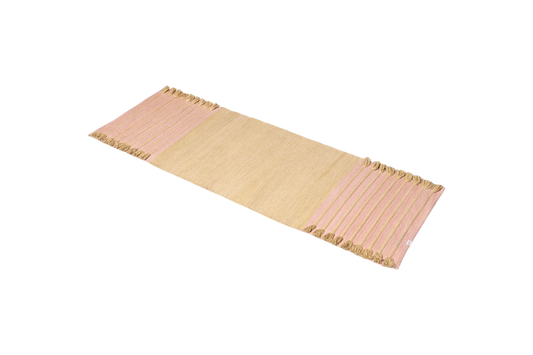 Harda and Madder Root Ayurvedic Yoga Mat by Bennd Yoga, featuring rectangular beige design with pink-striped edges and tasseled ends, crafted from organic cotton, set against a white background.