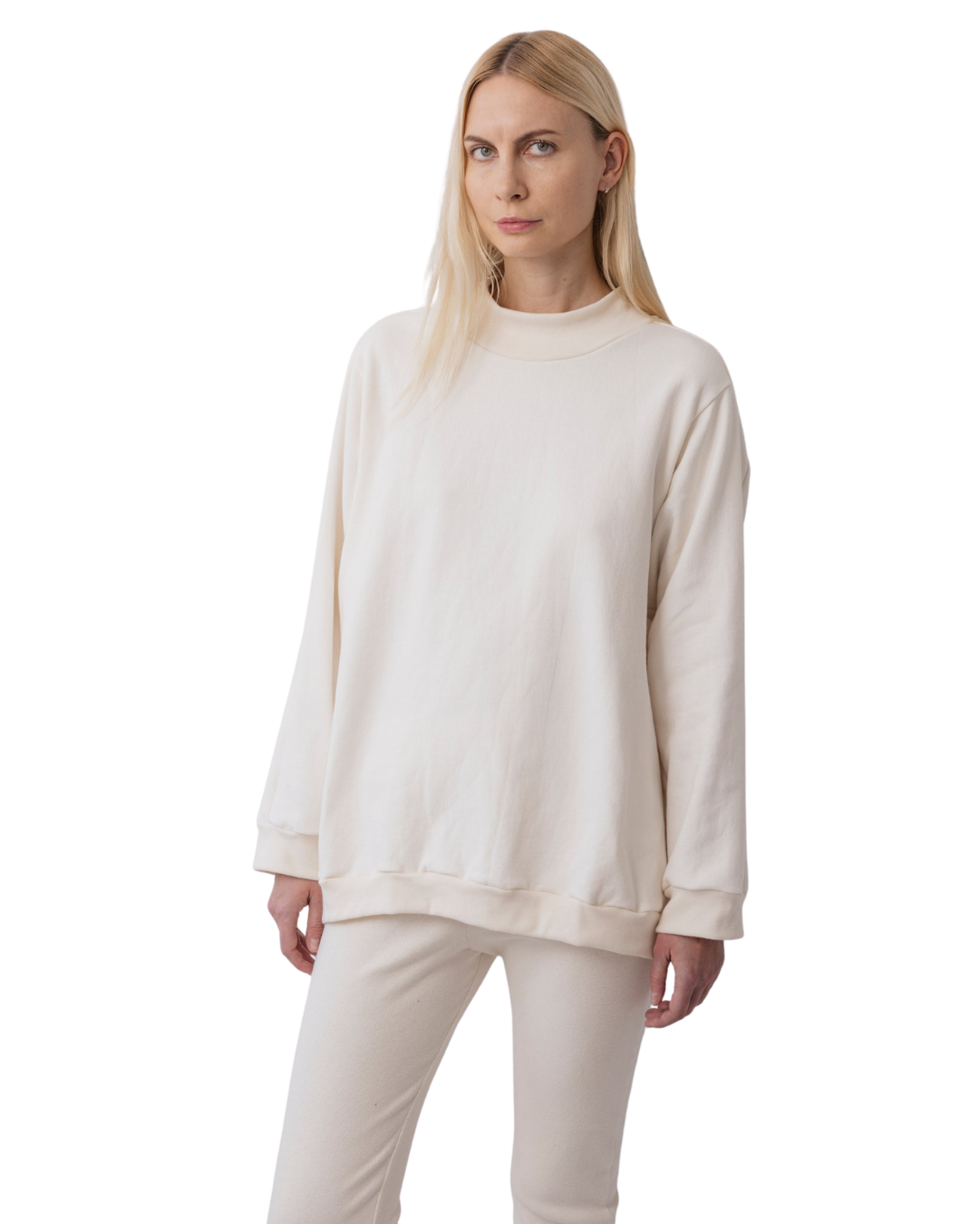 A person with long blonde hair wears Wol Hide's Big Sweatshirt in Natural, paired with matching pants, and stands against a plain white background.