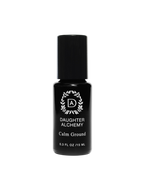 A 0.3 fl oz (15 ml) bottle of Daughter Alchemy’s Calm Ground® Botanical Calming Oil, with a black cap and a circular leaf design around "DA," crafted to help support anxiety relief.