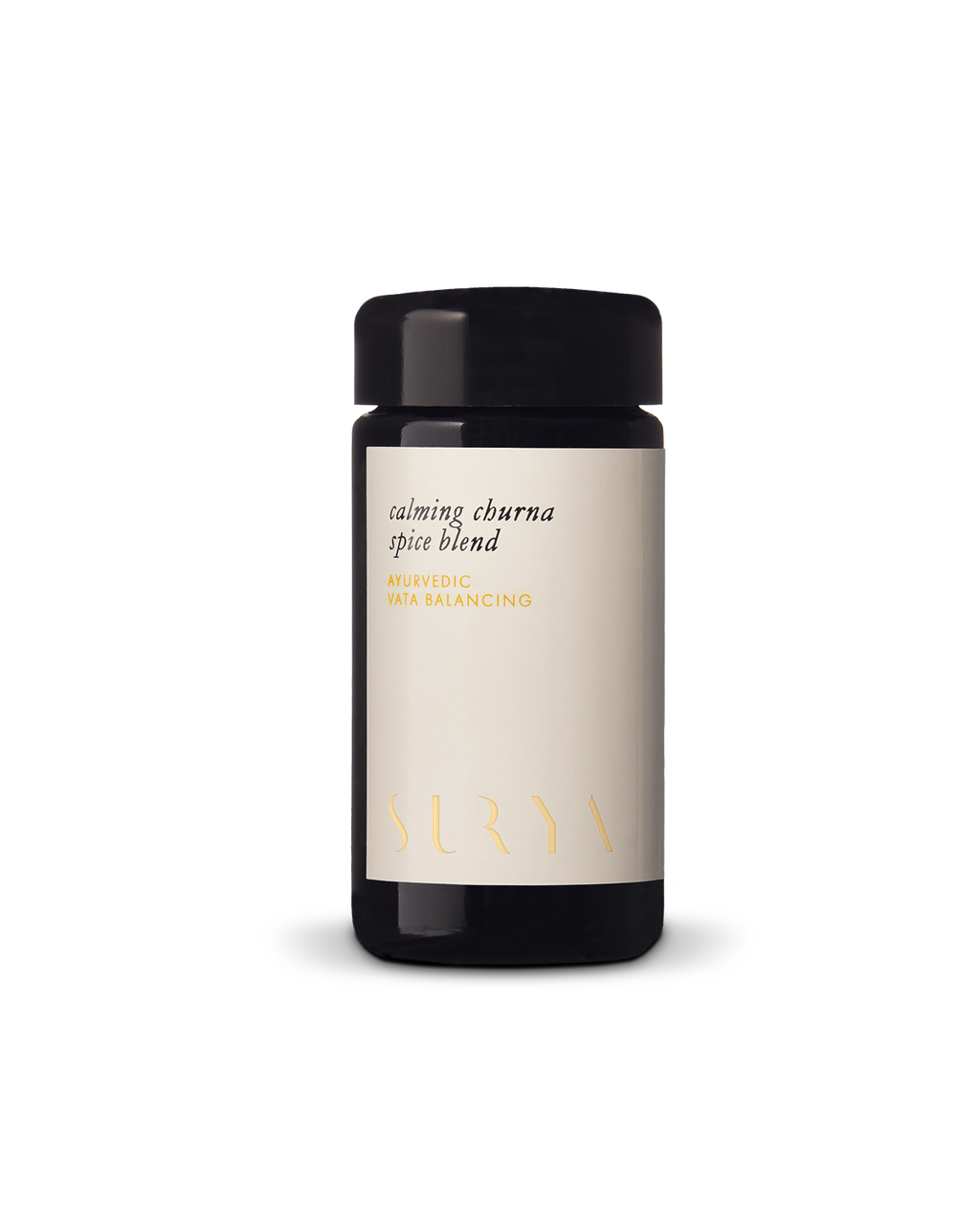 A dark glass jar with a beige label reading "Calming Digestive Spices" by Surya, displayed on a plain white background—ideal for adding depth to vegetables or cooking dahl.