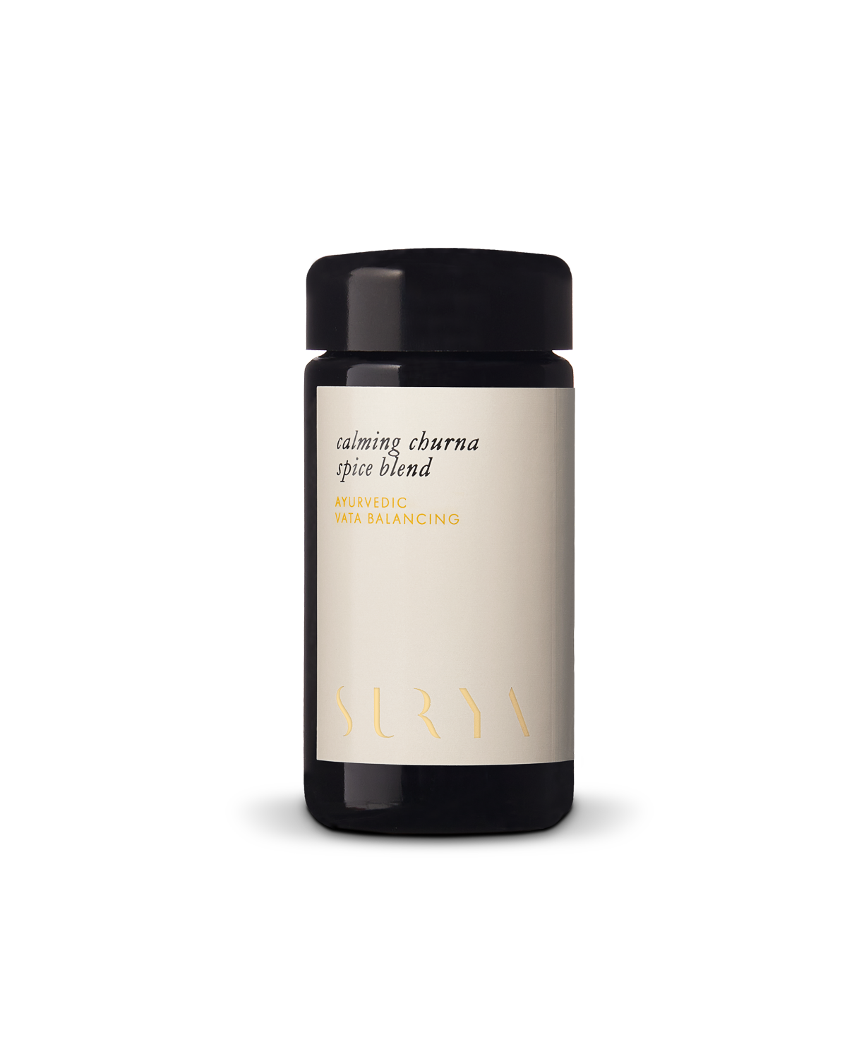 A dark glass jar with a beige label reading "Calming Digestive Spices" by Surya, displayed on a plain white background—ideal for adding depth to vegetables or cooking dahl.
