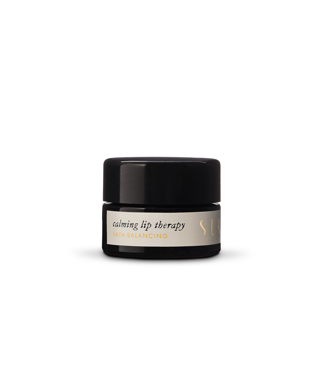 A small black jar of Surya's Calming Lip Therapy rests on a plain white background, featuring an organic lip balm crafted for soothing comfort.