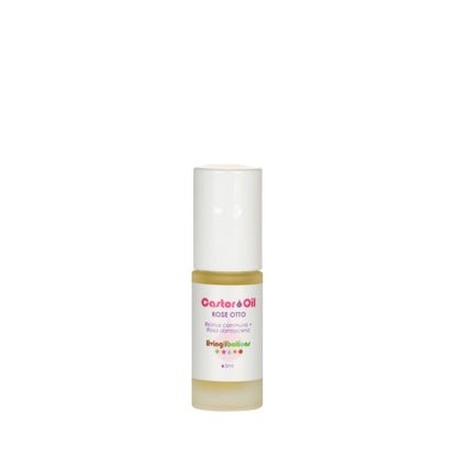 A 15 ml bottle of Living Libations' Castor Oil + Rose Otto, featuring a white cap and label with text emphasizing its rich ricinoleic acids, is displayed simply against a plain white background.
