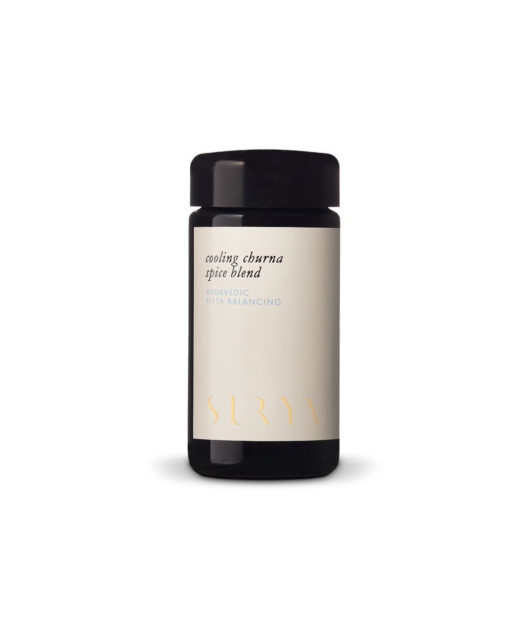 A black jar with a light label reading "Cooling Digestive Spices" from Surya, ayurvedic and pitta balancing, perfect for cooling and cooking dahl, photographed against a plain white background.