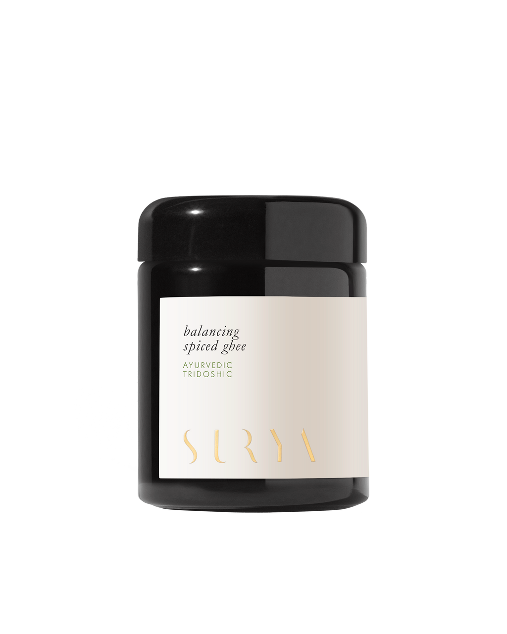 A black jar labeled "Surya Spiced Ghee, Ayurvedic Tridoshic" rests on a white background—ideal for Ayurvedic cooking with nourishing organic ghee.
