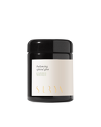 A black jar labeled "Surya Spiced Ghee, Ayurvedic Tridoshic" rests on a white background—ideal for Ayurvedic cooking with nourishing organic ghee.