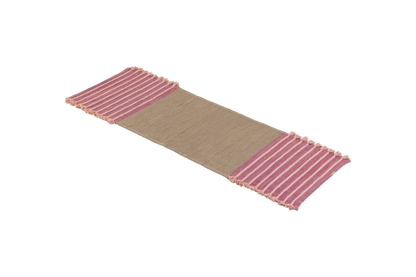 Product: Dark Harda and Sappan Wood Ayurvedic Yoga Mat by Bennd Yoga  
Description: A woven yoga mat crafted from organic materials showcases a beige center with pink striped fringed edges, presented on a plain background.