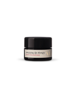 A small black jar labeled "Energizing Lip Therapy" by Surya on a plain white background, ideal for anyone seeking a nourishing and natural daily lip balm.