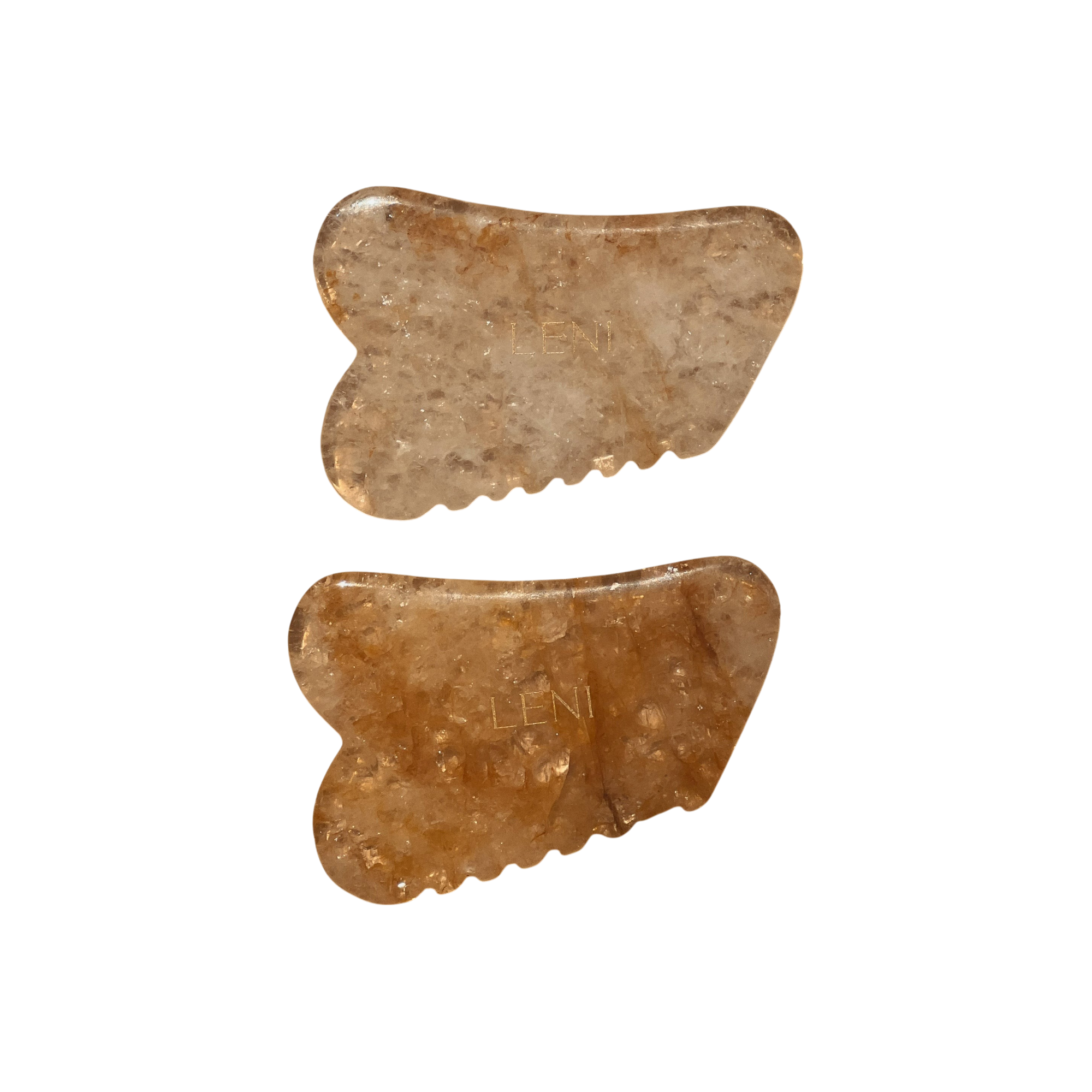 Two brown, translucent THE GUASHA TOOL stones by LENI, each engraved with "LENI" and featuring carved edges, are shown side by side on a white background. They are ideal for lymphatic drainage and facial massage.