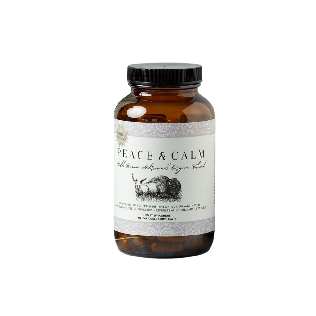 A brown glass bottle with a black screw cap, labeled "Peace and Calm- Wild Bison Adrenal Organ Blend" by Wild Mamas. The white label shows a bison image and product info. Contains 180 capsules of bison adrenal supplement.