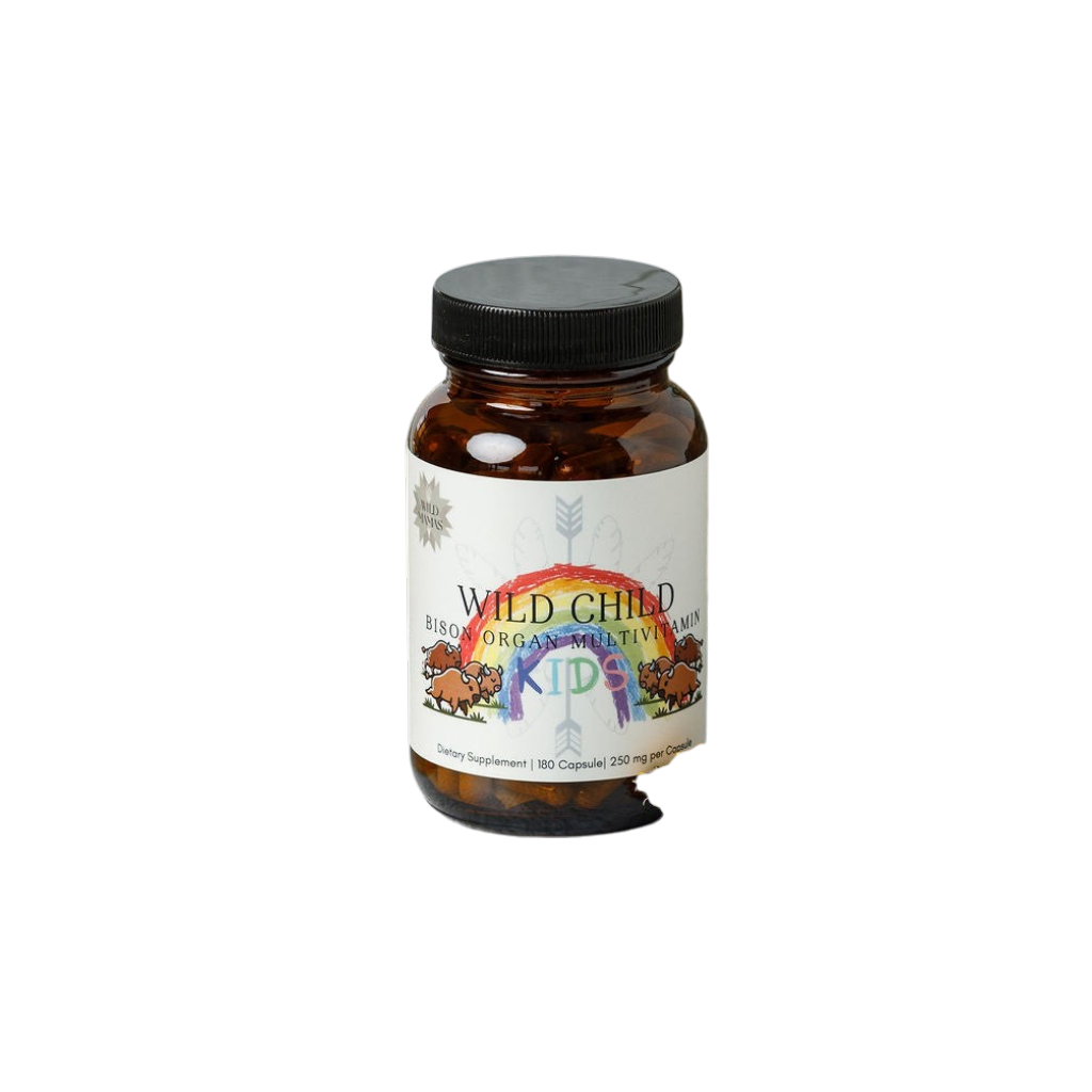 A brown bottle labeled "Wild Mamas Wild Child - Complete Multivitamin For Kids" with a black cap features colorful rainbow artwork and bison illustrations, offering child-friendly ancestral nutrition in a multivitamin supplement.