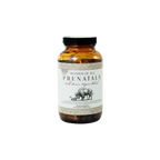 A brown glass bottle labeled "Mother of All Prenatals" by Wild Mamas, with a cow and calf illustration, contains a prenatal supplement rich in bioavailable nutrients and features a black cap and white label with black text.