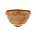 Discover the Katakuchi Matcha Tea Bowl by Chafinity Tea. This ceramic bowl, in earthy tones of brown and beige, features a rounded shape and a smooth, shiny glaze. Its small, subtle spout is ideal for easy pouring. Perfect for enhancing your Chafinity Tea moments against a plain black background.