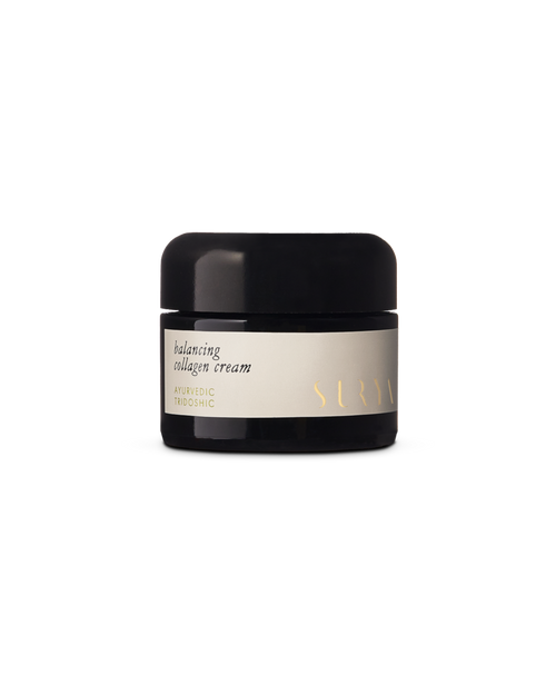 A black jar with a beige label reads "Balancing Collagen Cream" and "Surya." This minimalist natural face cream emphasizes Ayurvedic skincare, shown against a plain white background.