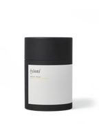 A black cylindrical container with a white label that reads "Surya (y)oni Fertility Steam" in minimalist font, featuring Ayurvedic herbs for yoni fertility steam, set against a plain white background.