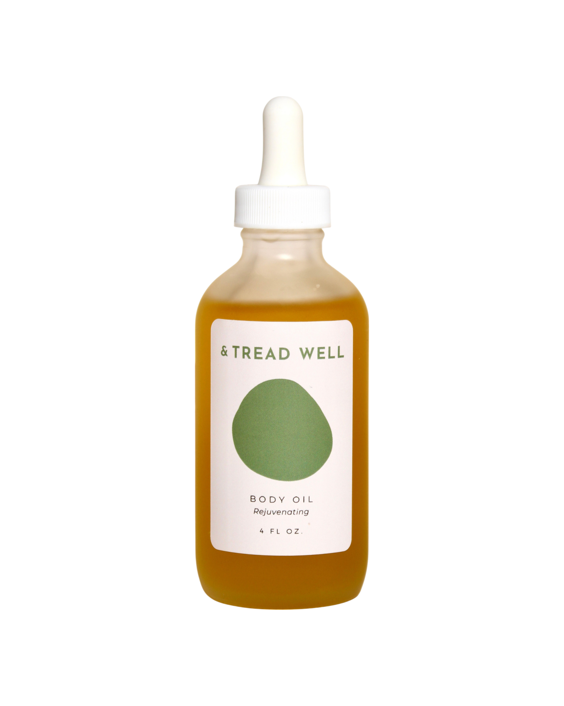 A clear glass dropper bottle of & Tread Well Body Oil, filled with golden oil and featuring a white and green label, designed to nourish skin, is shown against a black background.