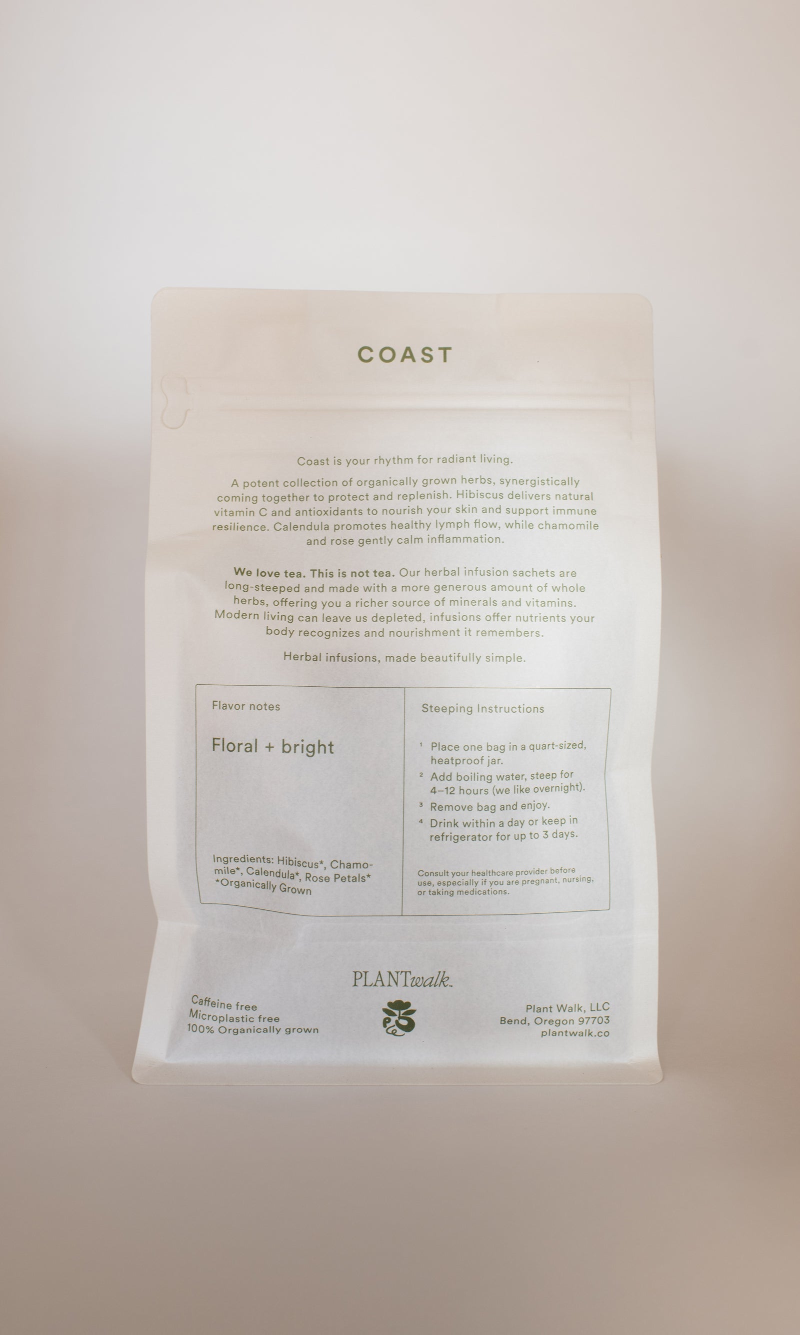 A white tea package labeled "COAST | Antioxidant Protection Herbal Infusion" features flavor notes, steeping instructions, ingredients, and a minimalist design highlighting PLANTWALK branding from Bend, Oregon.