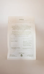 A white, resealable pouch labeled "FIELD | Everyday Minerals Herbal Infusion" by PLANTWALK. The packaging features plant-based minerals, earth and floral flavor notes, mineral-rich water steeping instructions, and soft green brand details.