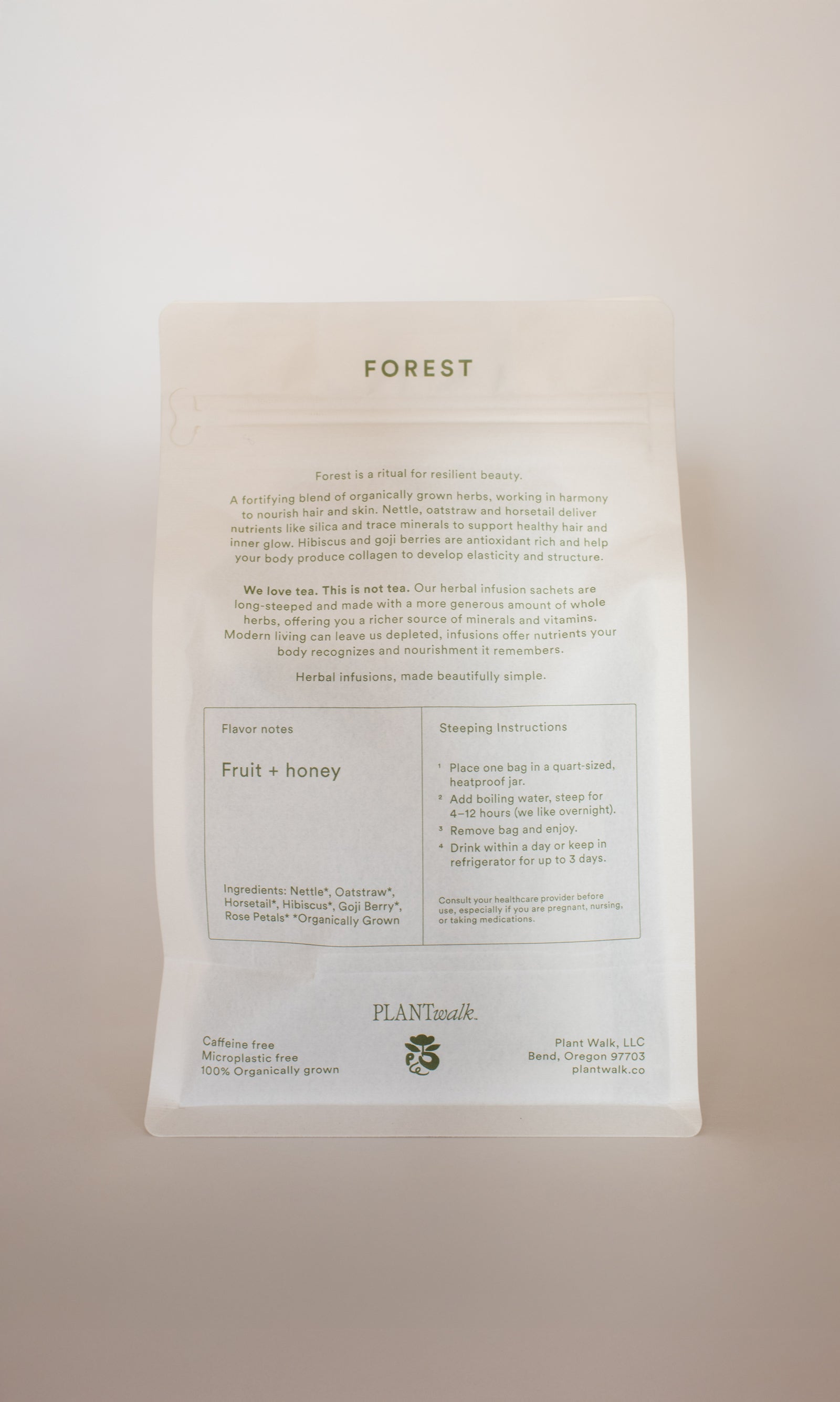 A white tea package labeled "FOREST | Healthy Hair & Skin Herbal Infusion" by PLANTWALK features text on fruit and honey notes, silica for hair and nail strength, steeping instructions, and stands upright against a light background.