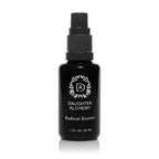 A 1 fl oz (30 ml) black pump bottle of Daughter Alchemy Radical Restore® Botanical Energizing Spray, featuring a white logo and text, is set against a white background.