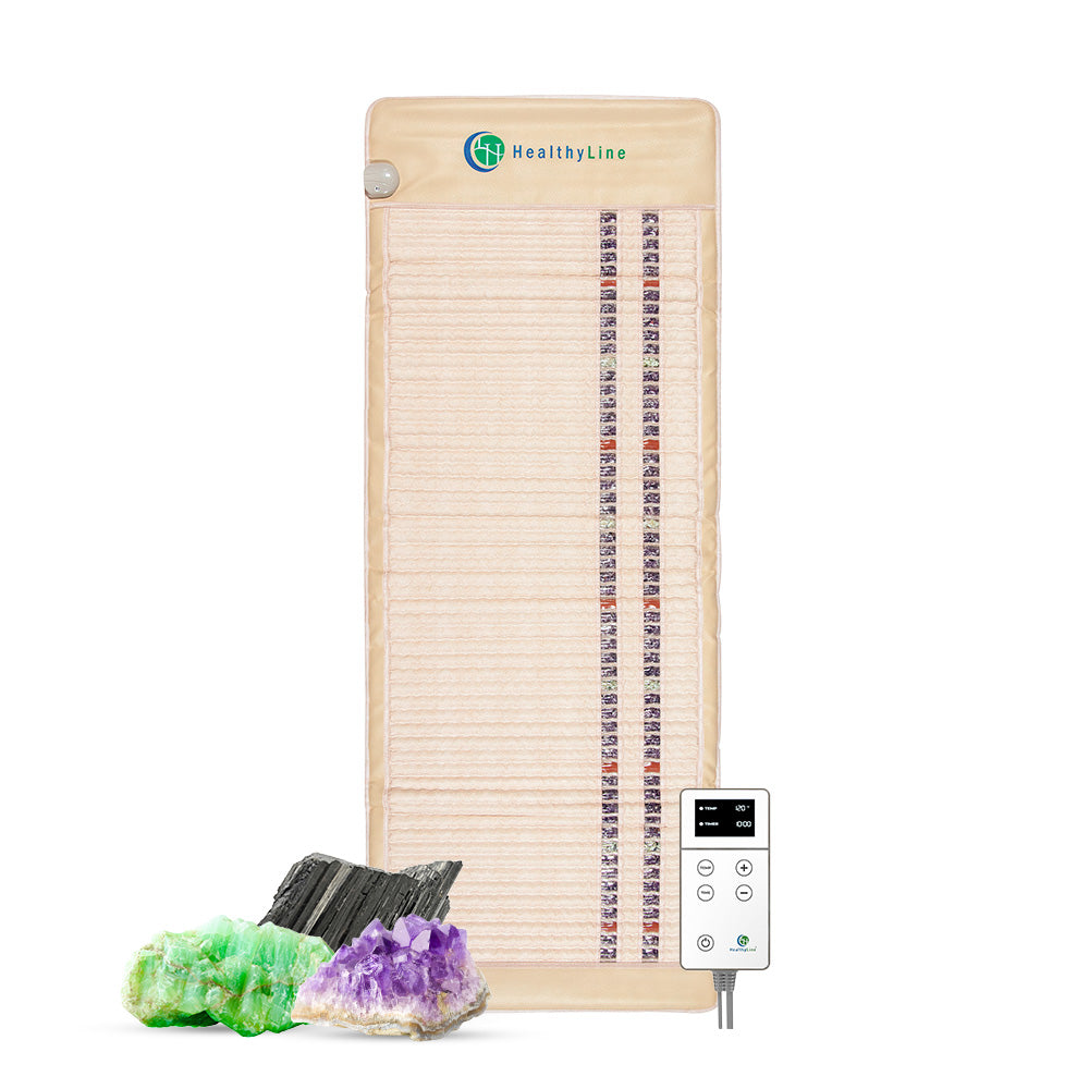 A rectangular beige SOFT Series | Far Infrared Heating Mat by HealthyLine, featuring rows of Amethyst, Jade, and Tourmaline stones, is shown with a digital control panel and three crystals (green, black, purple) in front.