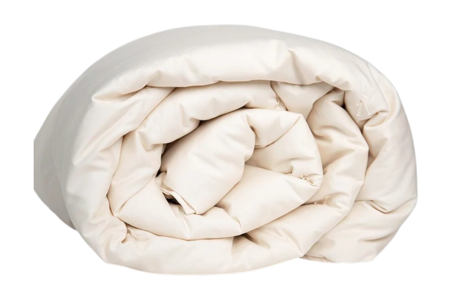The Shepherd's Dream Summer Weight Wool Comforter, in a cream color, is neatly rolled and displayed against a plain white background.