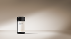 A black bottle with a white label reading "Cooling Digestive Spices" by Surya stands on a smooth surface, softly lit against a beige background—hinting at a cooling spice blend ideal for cooking dahl.