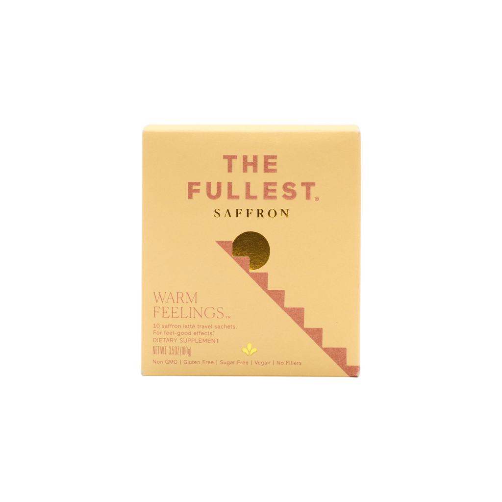 A yellow box labeled "The Fullest Saffron Latte 10 Single-Serving Sachets" features a gold semicircle and stepped design. Text highlights "WARM FEELINGS," mood support, plus vegan, non-GMO, gluten-free, and sugar-free attributes.