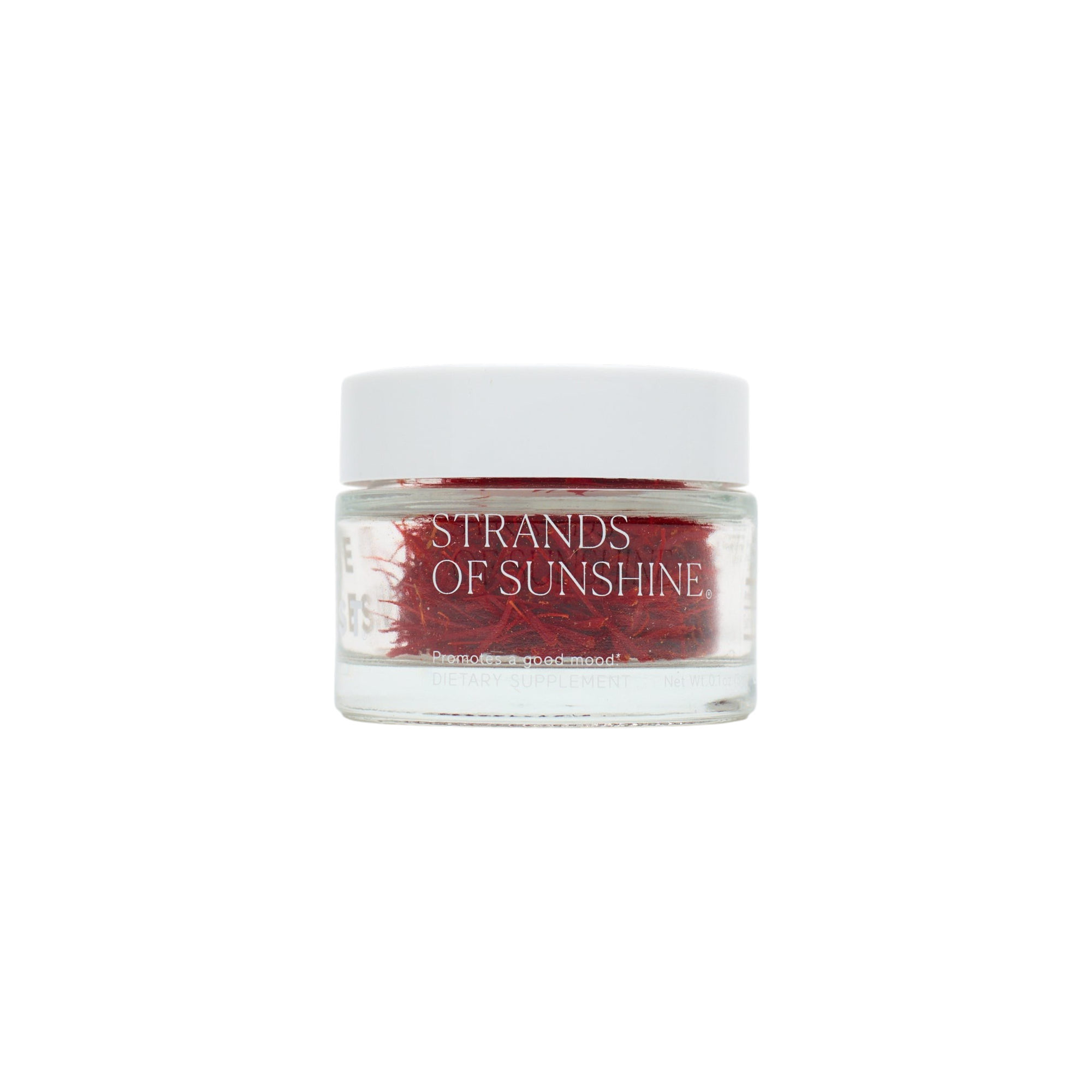 A small clear glass jar with a white lid holds pure Saffron Threads from The Fullest. The label reads “STRANDS OF SUNSHINE.” Set against a plain white background, it’s ideal for mood support and culinary delights.