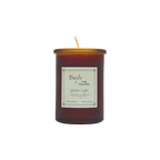 A brown glass jar candle called "Gather Light - Saffron Beeswax Tallow Candle" by Baile features a gold lid and white label. The unlit, centered wick is non-toxic, and the product is shown against a plain white background.