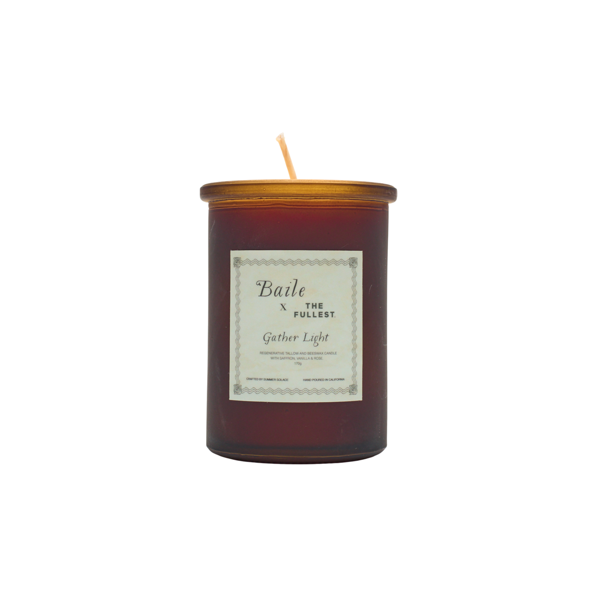 A brown glass jar candle called "Gather Light - Saffron Beeswax Tallow Candle" by Baile features a gold lid and white label. The unlit, centered wick is non-toxic, and the product is shown against a plain white background.