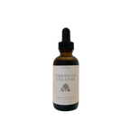 The Embodied Creator Tincture from Moon Canyon Healing comes in a brown glass bottle with a black dropper cap. The label, which features a minimalist design with a small rose icon and specifies the product as a tincture measuring 2 fl. oz. (59 mL), stands out against the black background.
