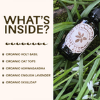 A bottle of WOODEN SPOON HERBS Tranquility Tonic rests on green grass, with text listing its calming herbal blend: organic holy basil, oat tops, ashwagandha, English lavender, and skullcap.