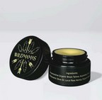 A black jar of Wild Mamas Honey Bee (Raw Honey)–Wild Bison Tallow Balm, with a feather- and arrow-decorated lid, is shown open to reveal yellow balm inside. Ingredients like wild bison tallow appear in white text on the jar.