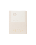 A beige 25 oz box labeled “Calming Bath Soak” by Surya features “Ayurvedic Vata Balancing,” is enriched with Ashwagandha, displays “Single Use Spa Therapy,” and has the brand name embossed at the bottom.