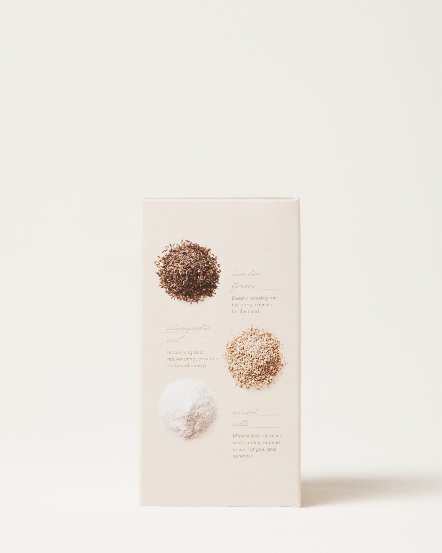 A beige box labeled "Calming Bath Soak" by Surya features three ingredient piles on the front—brown seeds, beige ashwagandha powder, and white powder—each with a description beside it to rejuvenate your senses.