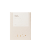 A beige box of Surya Cooling Bath Soak with minimalist packaging, labeled as an Ayurvedic, anti-inflammatory soak for single-use spa therapy and Ayurveda skin care. Net weight: 24.75 oz (0.7 kg).