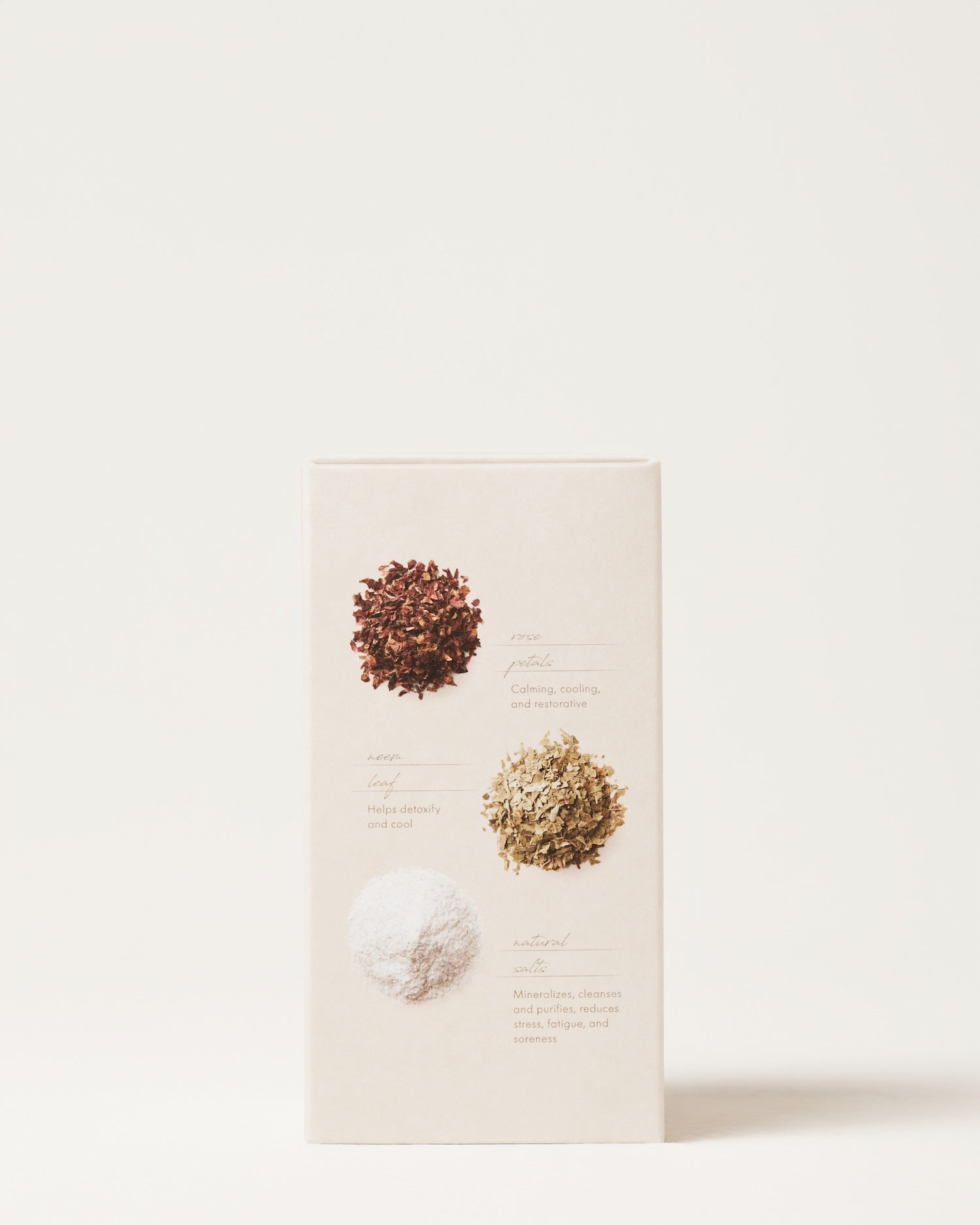 A beige box of Surya Cooling Bath Soak shows three ingredients on the back—brown flakes, greenish dried leaves, and white powder—each adding to this Ayurvedic soak made to harmonize emotions.