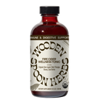 A brown glass bottle labeled “WOODEN SPOON HERBS Fire Cider,” made with organic apple cider vinegar, honey, and herbs. The USDA organic tonic offers immune and digestive support.