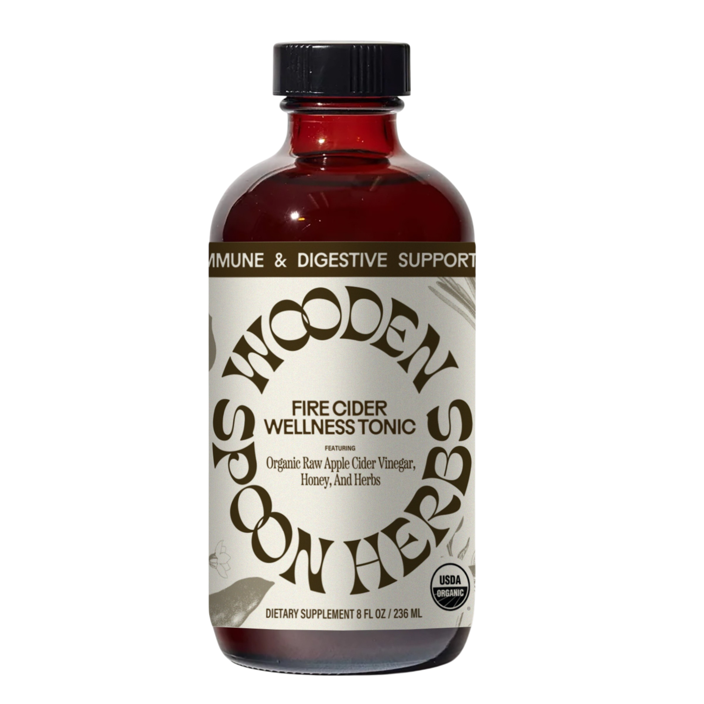 A brown glass bottle labeled “WOODEN SPOON HERBS Fire Cider,” made with organic apple cider vinegar, honey, and herbs. The USDA organic tonic offers immune and digestive support.